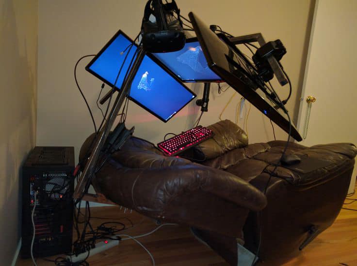 This meme is an image of a computer setup with multiple monitors, a keyboard, and a chair, but everything is severely tilted and broken, with monitors hanging from the ceiling and the chair is upside down. The text "I can smell the desperation" is written on the screen of one of the monitors. The image is a humorous representation of a person's computer setup being severely damaged, likely due to a long gaming session or a power outage.